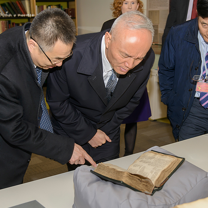 Chinese men looking at book